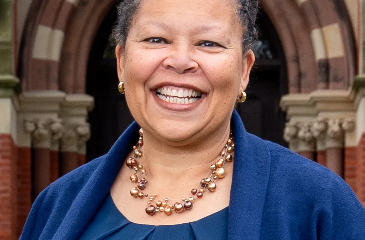 Sarah Willie-LeBreton smiling outdoors in front of College Hall. Square cropped photo, close-up.