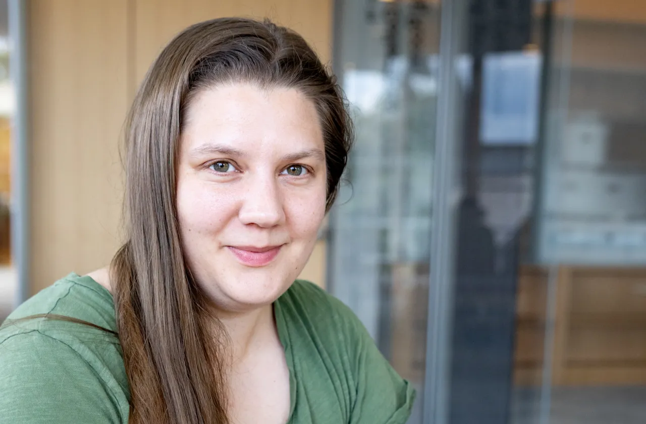 Kady Wilson holds a black and white photo of her great-grandmother