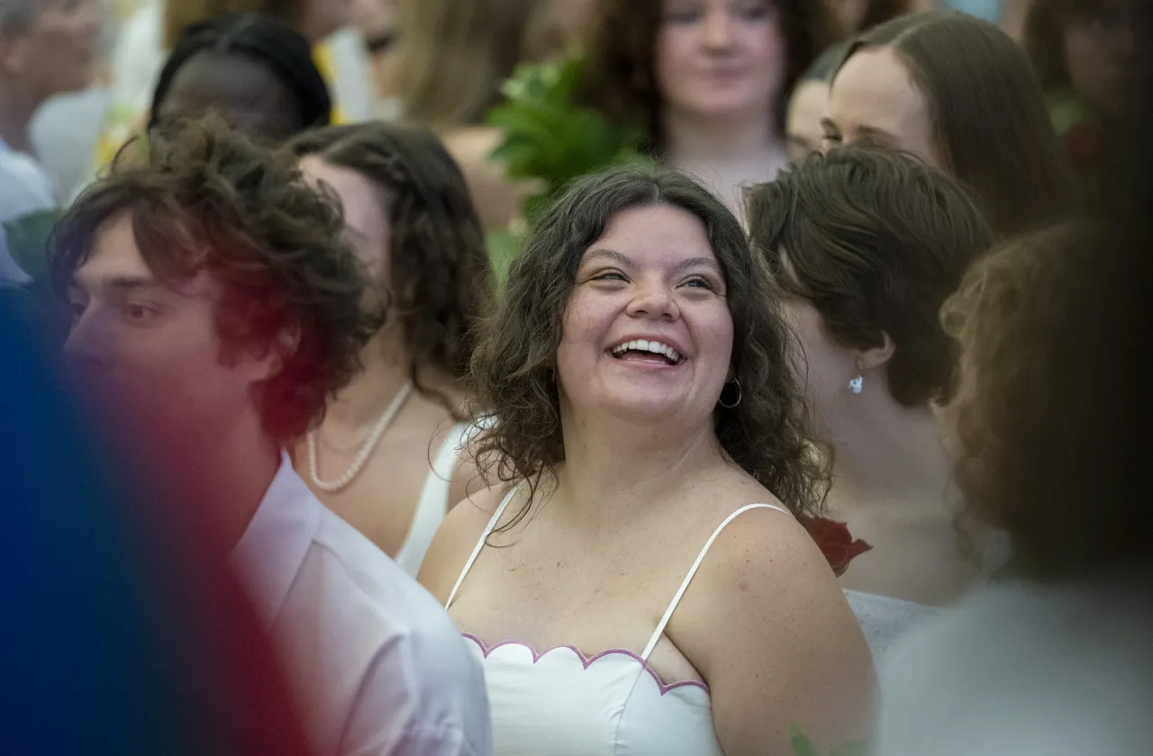 A senior smiles in the crowd on Ivy Day