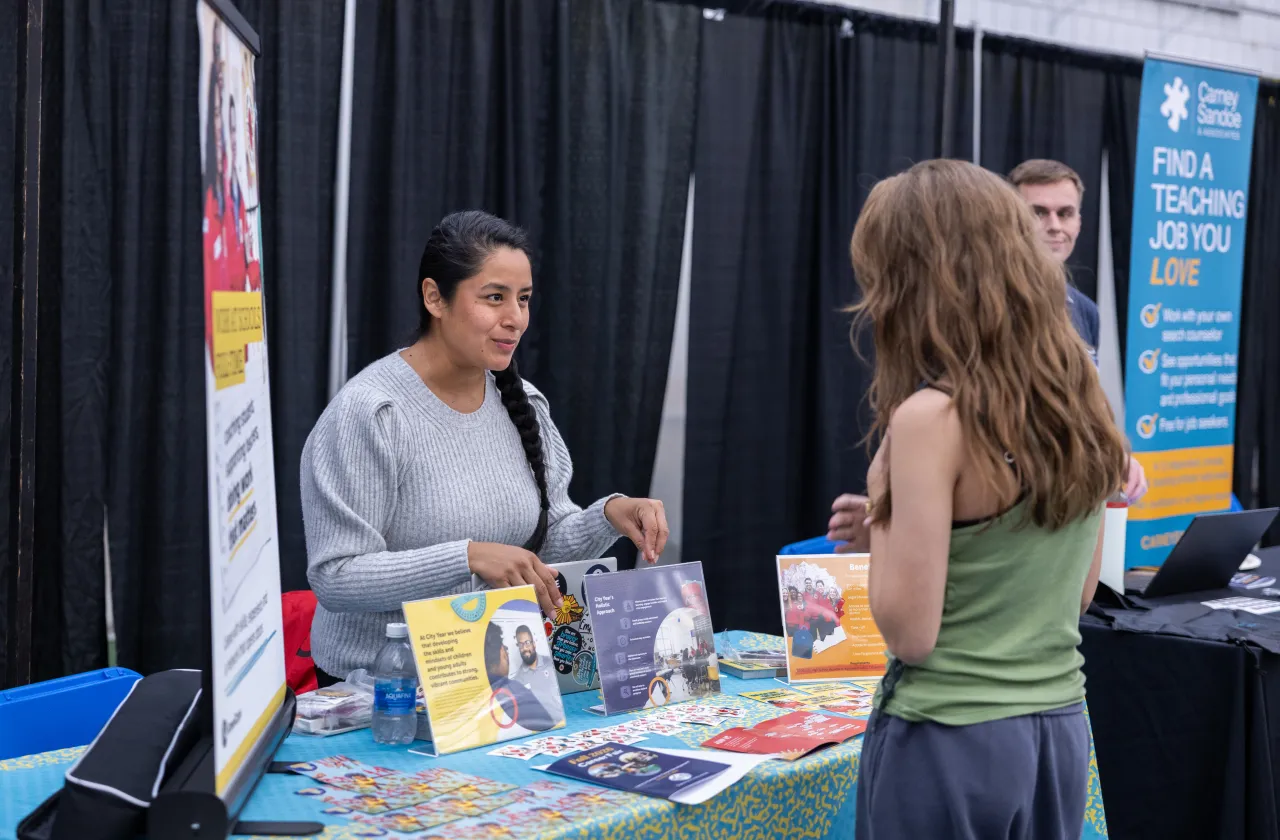 An employer interacting with a student at the Job & Internship Fair.