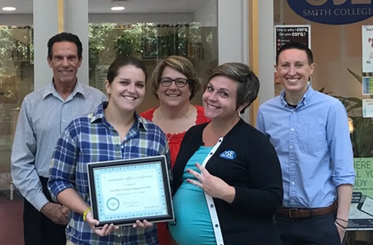Members of the Office of Student Engagement display their sustainability certificate