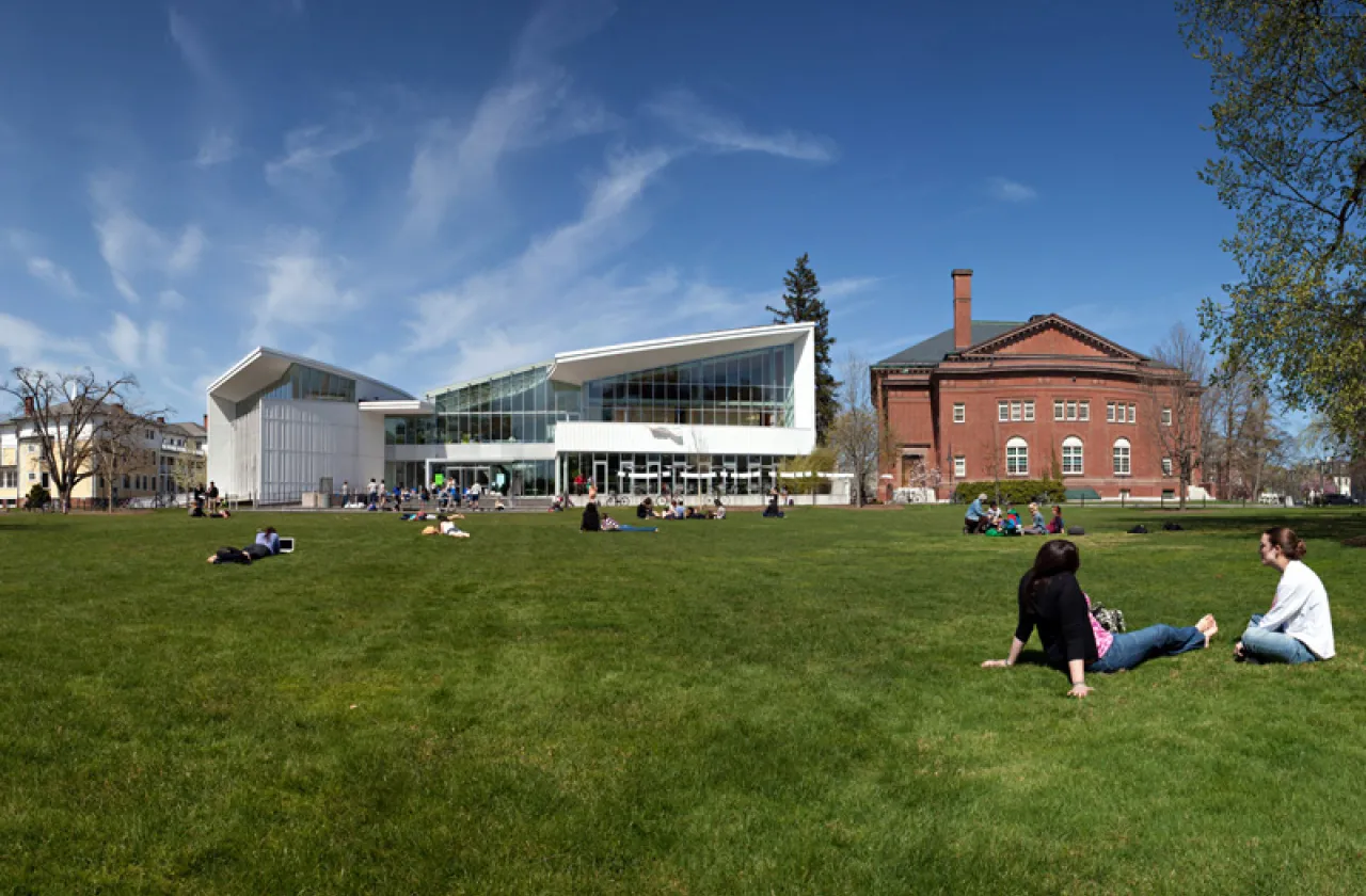 students studying on the lawn in front of the Campus Center and JMG on a bright summer day