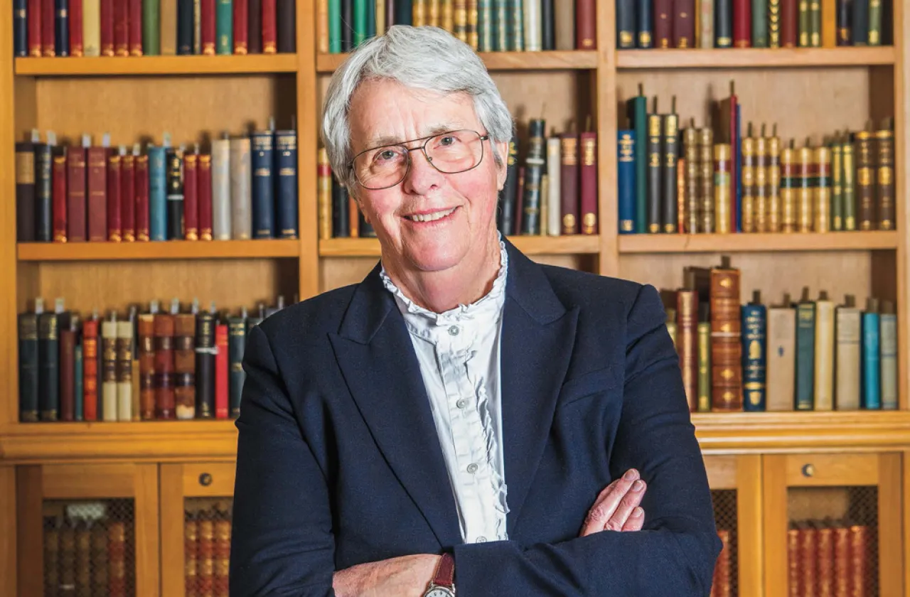 Lucy Marsh smiling in front of a bookcase