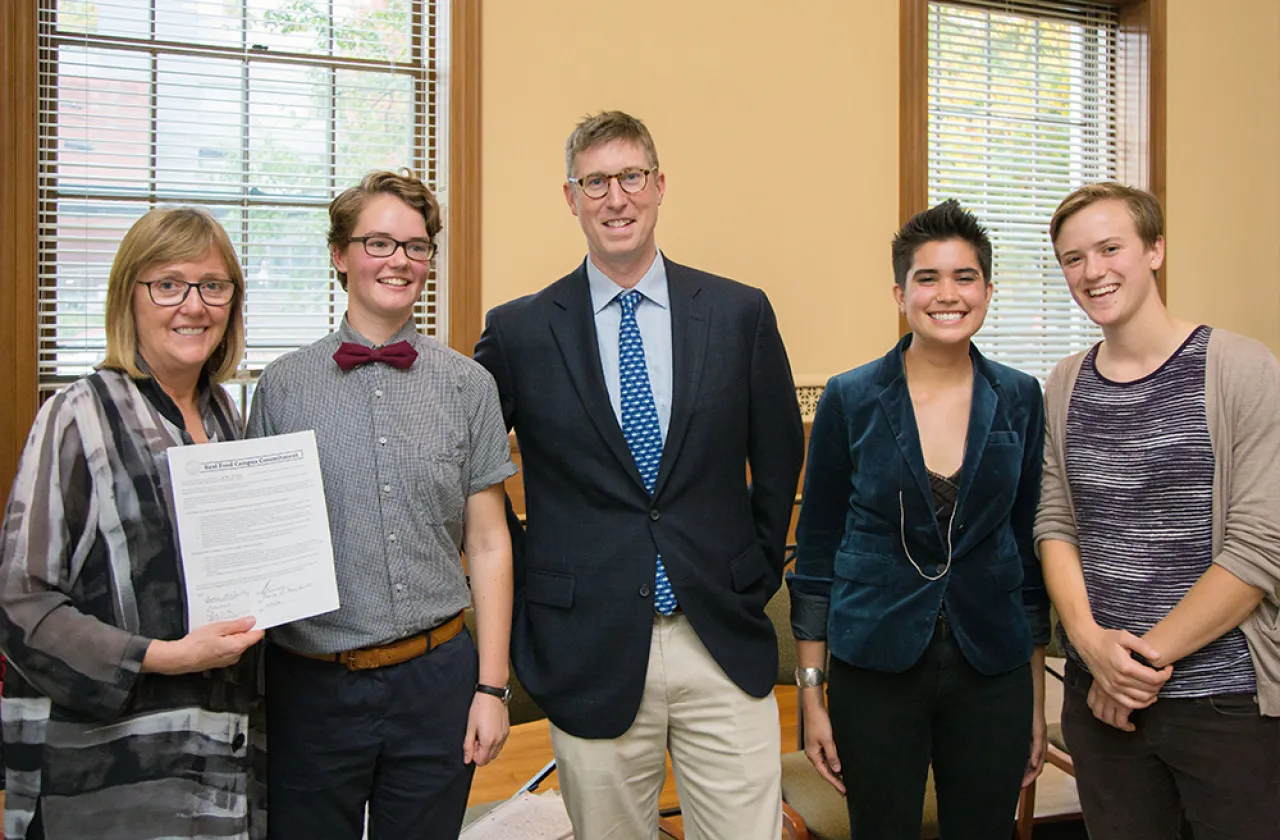President Kathleen McCartney displays the college's Real Food Challenge commitment