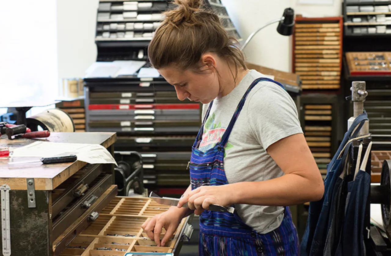 Student working in the type shop