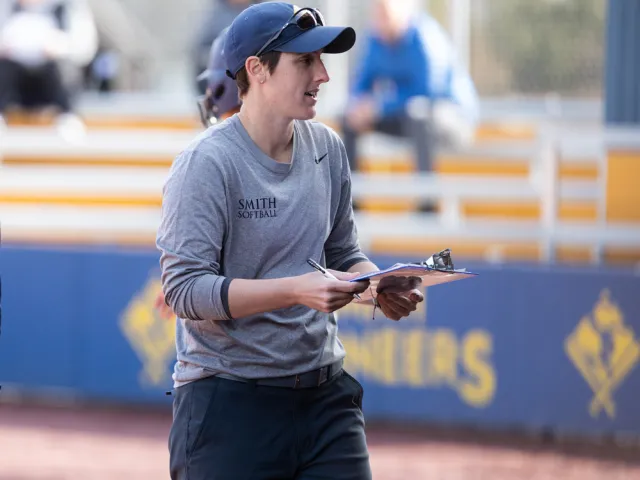 Coach Emily Lopez with a clipboard