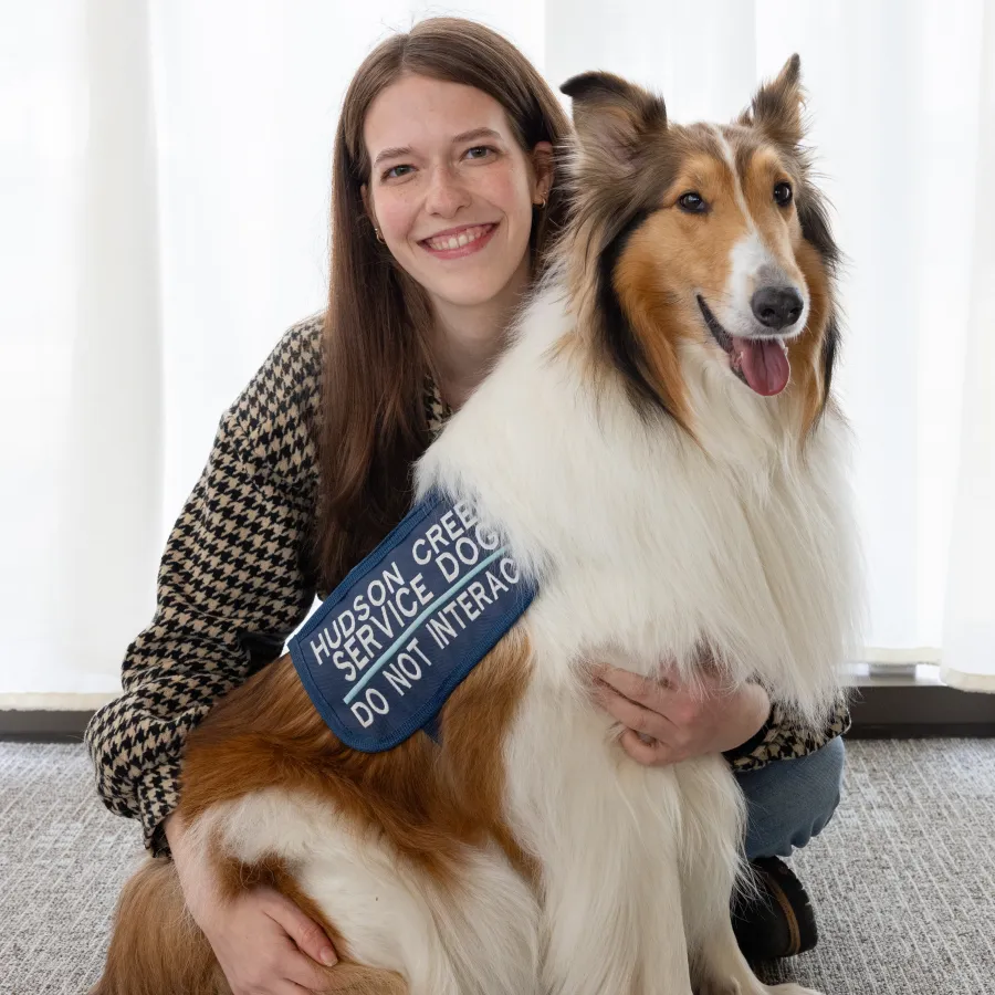 Indea Holt '27 smiles with her service dog, a rough collie named Laila