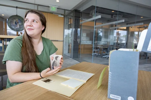Kady Wilson holds a black and white photo of her grandmother in Special Collections