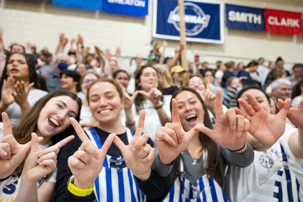 Fans cheering during a basketball game.