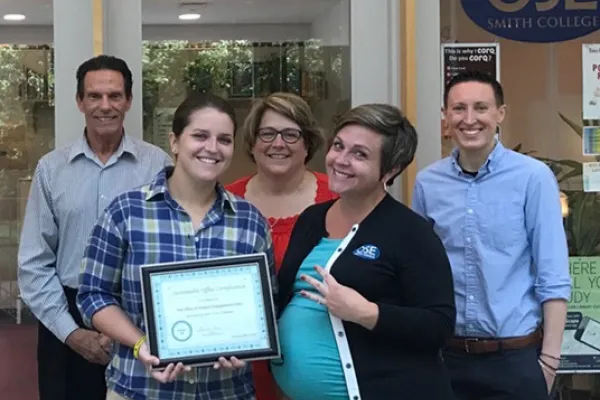 Members of the Office of Student Engagement display their sustainability certificate