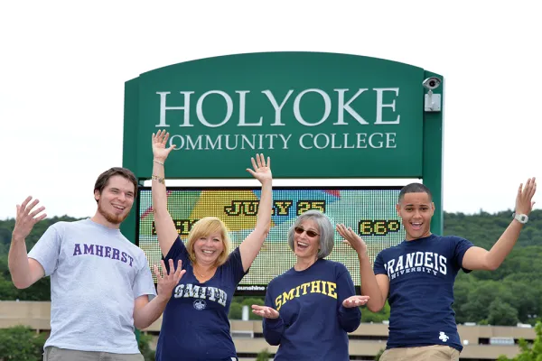 Four students pose in front of Holyoke Community College sign