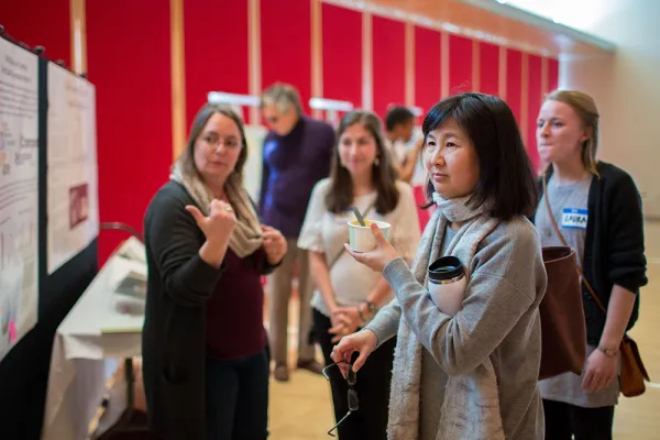 Maya Lin looks at posters describing student ideas for a new library