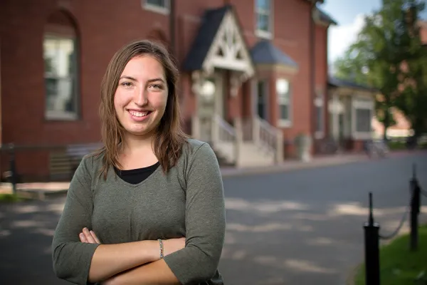 Angelica Radke '18 stands in front of Hatfield Hall, where she first took Smith classes as a senior in high school.