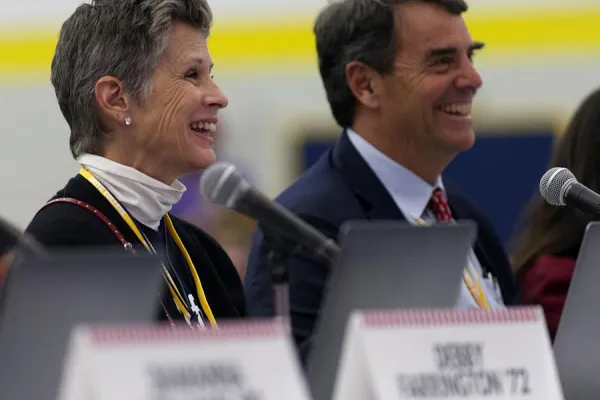 Tim Draper and Melissa Park Draper ’77 listen to student presentations 