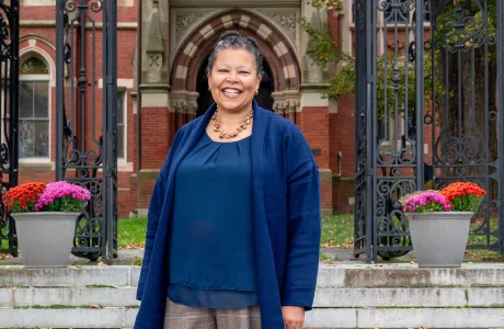 Sarah Willie-LeBreton smiling and standing outside of College Hall. 
