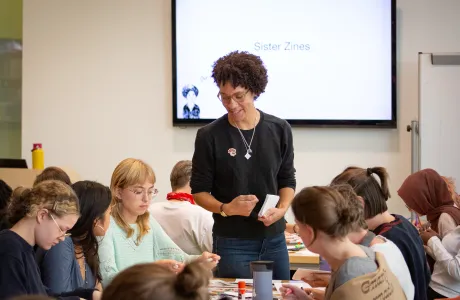 Ebony Flowers leads a zine workshop with students called "Sister Zines"
