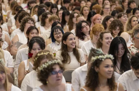A group of seniors dressed in white in the crowd during Ivy Day
