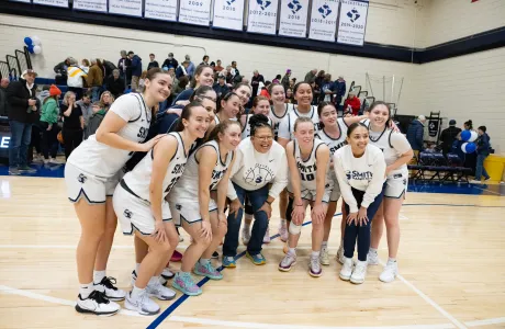 President Sarah on the basketball court with the team.