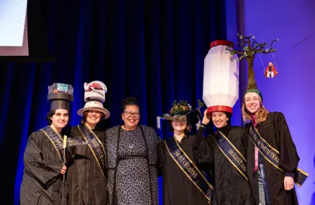 President Sarah with winners of the 2025 Rally Day hat competition on stage in John M. Greene Hall.