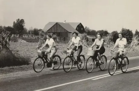 Smith students bicycle down the road on Mountain Day in 1950