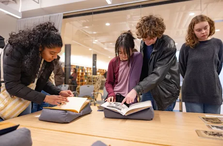 Students look at papers in Neilson Library on Cromwell Day.
