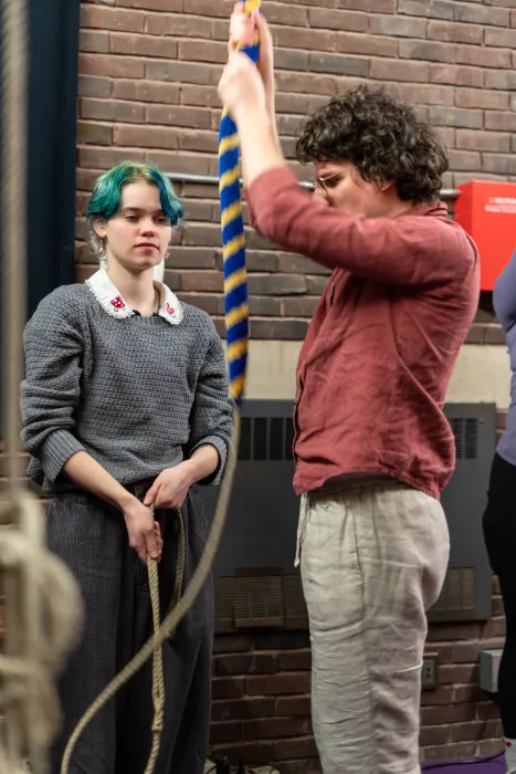 Two bell ringers practice on a rope in Mendenhall Bell Tower