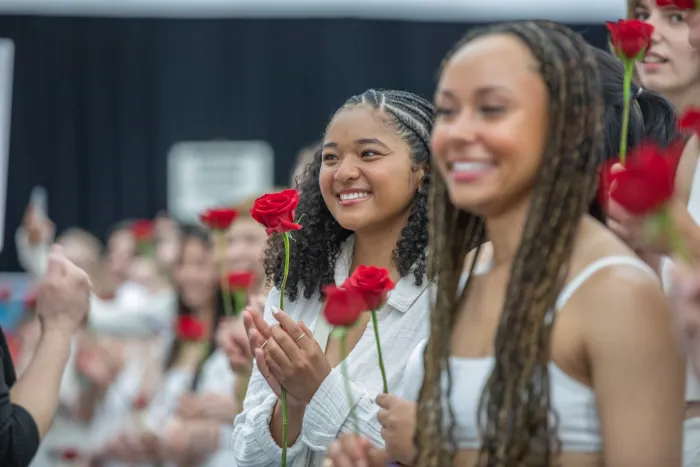 Students holding roses on Ivy Day