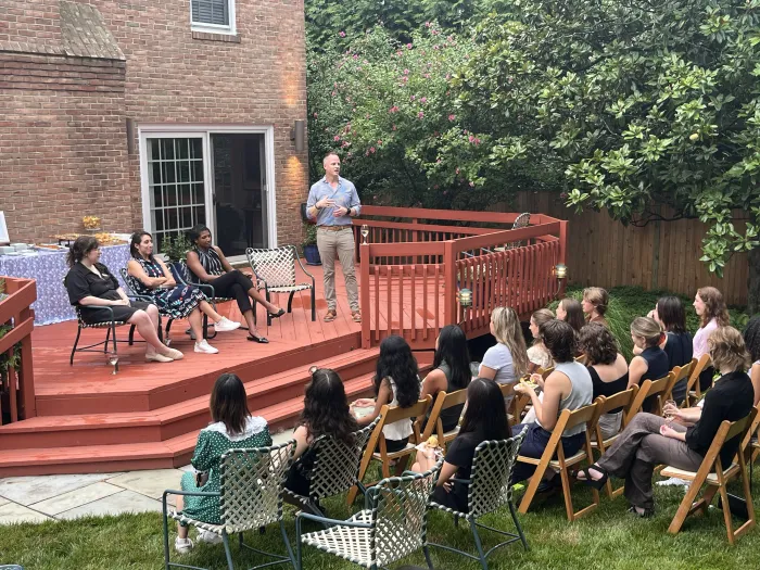 Assistant professor Brent Durbin moderates a panel of Smithies working in Washington DC at the home of Susan Rosenbaum '67, who hosted current students and alums for dinner and networking.