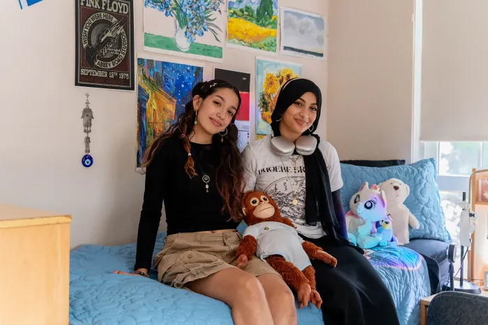 Two roommates laugh in their room in Lamont House