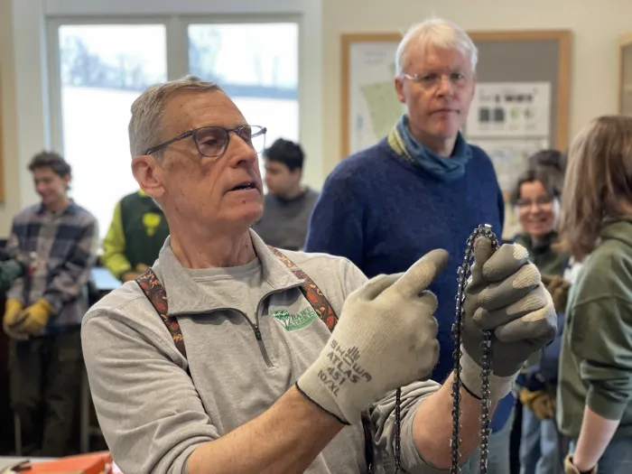Craig Houghton discusses chain saw safety before a workshop.
