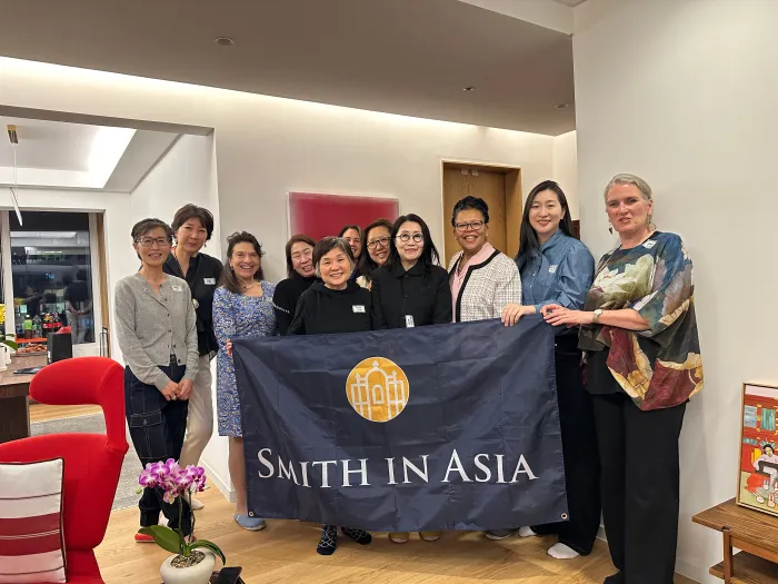 President Sarah Willie-LeBreton and Smith College alums holding a Smith in Asia banner.