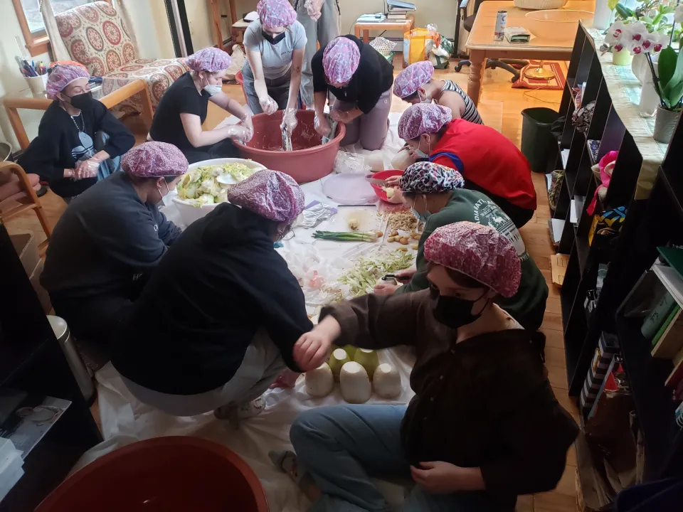 Students slicing vegetables to make kimchi 