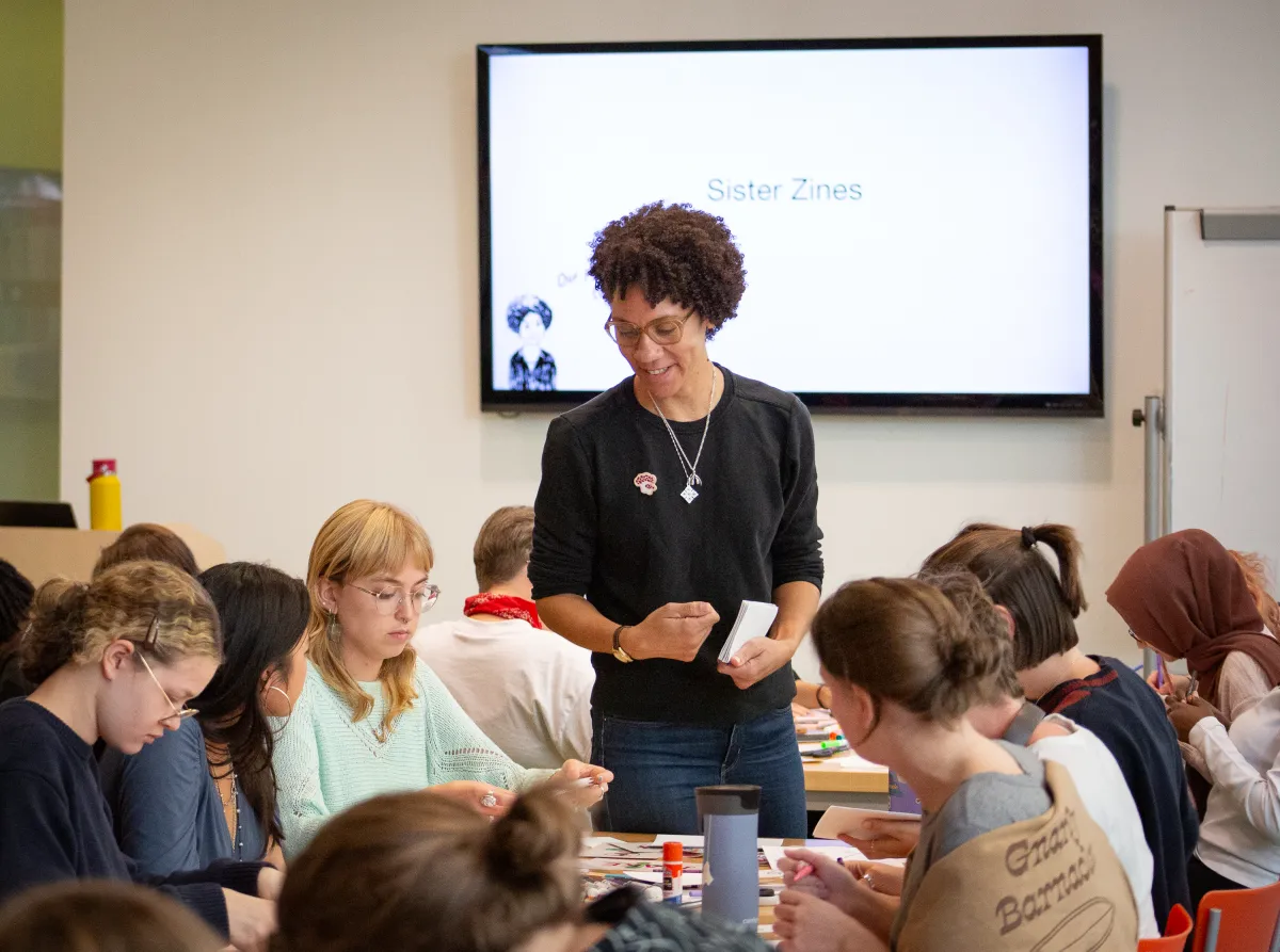 Ebony Flowers leads a zine workshop with students called "Sister Zines"