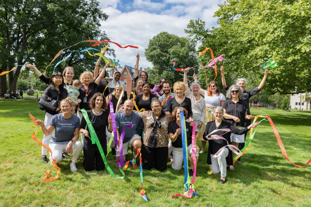 A group of people outside with colorful ribbons.
