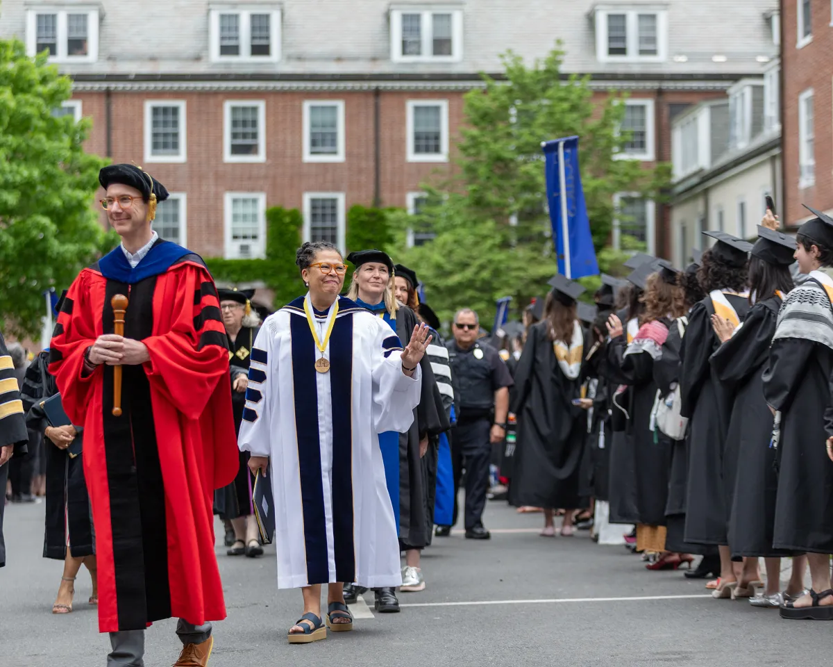 President Sarah waving to graduates in the Quad during Commencement 2025.