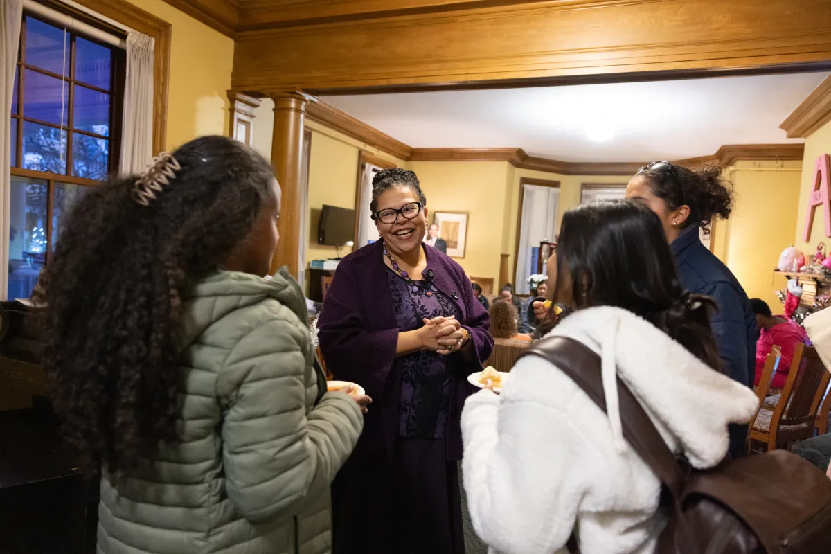President Sarah talking with students during a house tea.