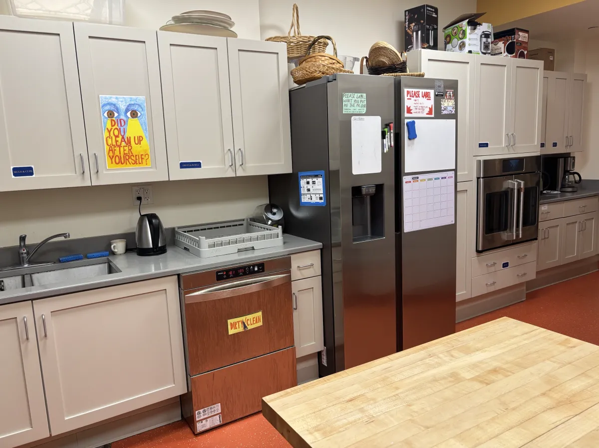 The renovated chapel kitchen, featuring stainless steel appliances, new cabinetry, and ample work space.