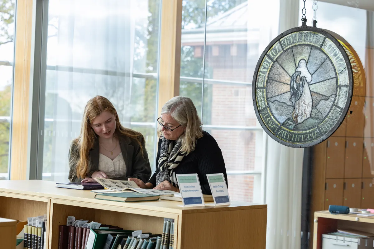 A Smithie and a family member look at materials in the archives during Family Weekend.