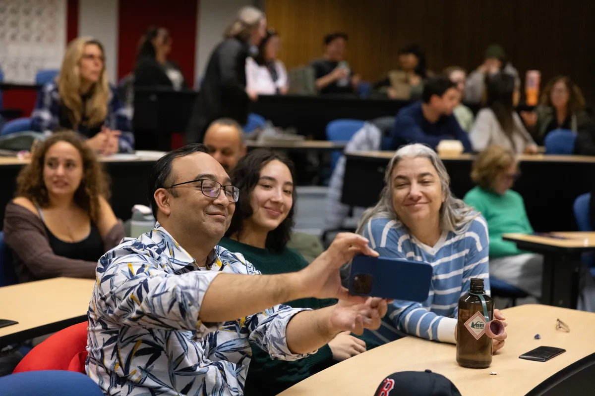 A family takes a selfie during Family Weekend