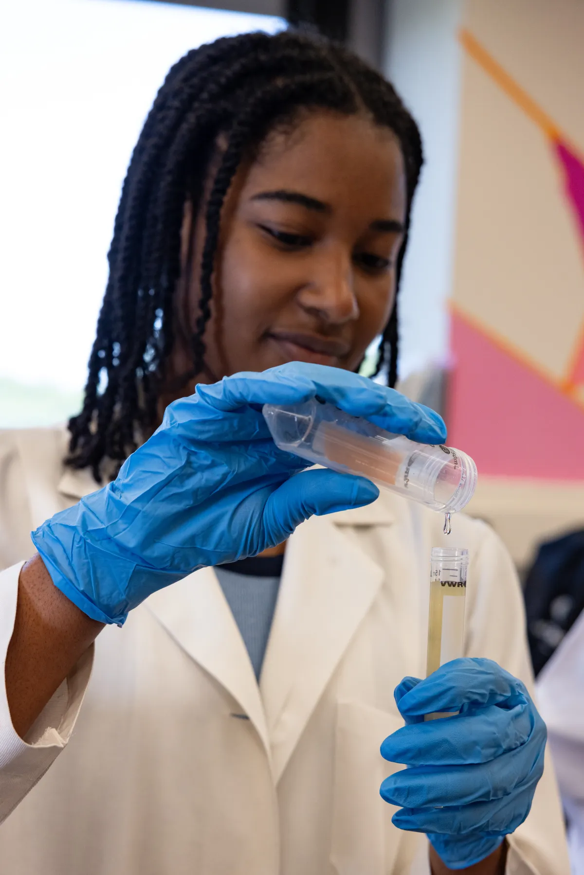 Student Lana Clarke holding two test tubes