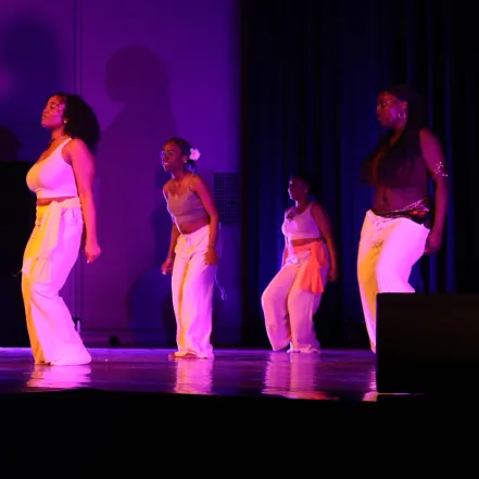 Students dancing in purple light